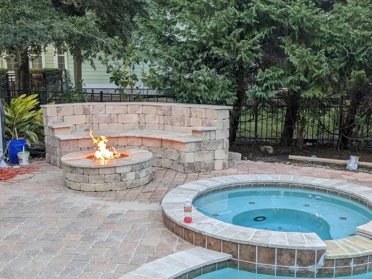 Custom fire pit installation with natural stone surround