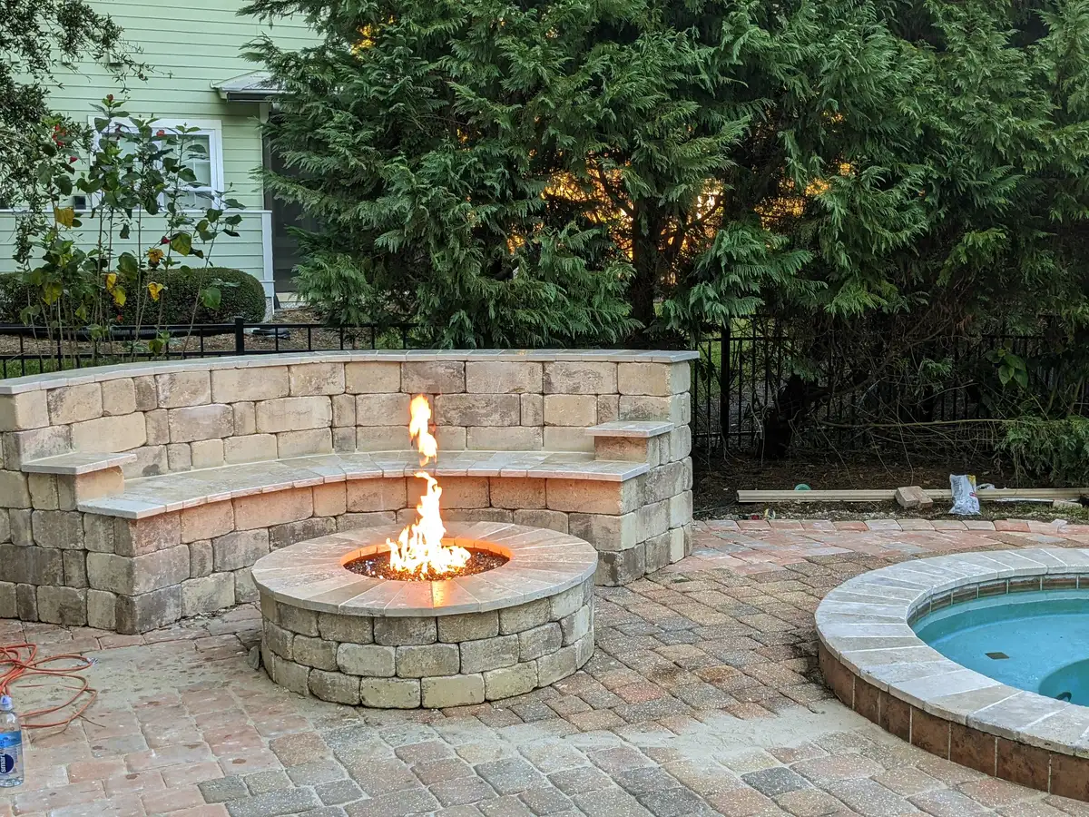 Fire pit integrated with outdoor living patio and landscape lighting in Northeast Florida