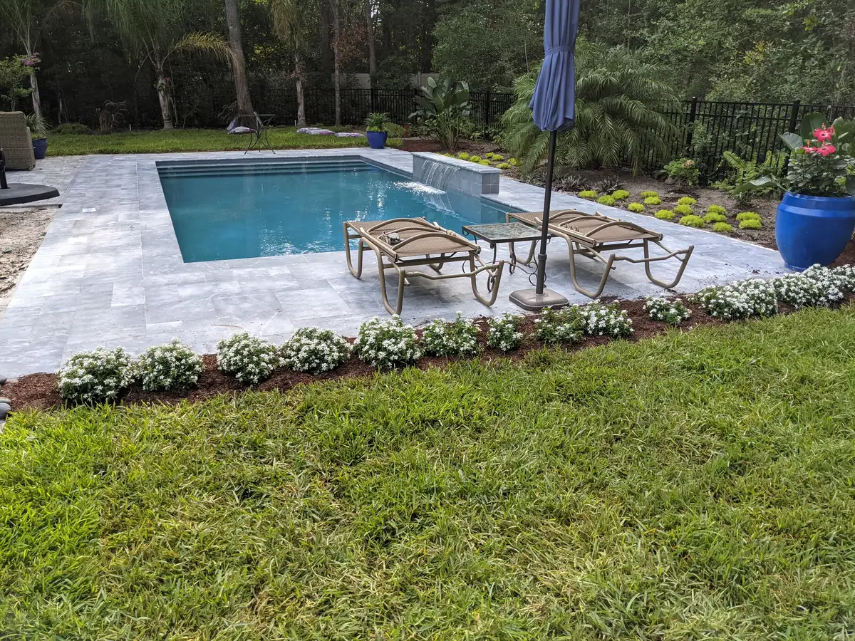 Outdoor living space with stone terrace and landscape lighting