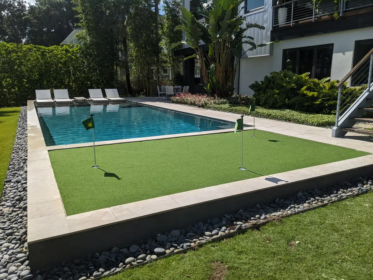 Landscaper installing naturalistic planting and stone details in Northeast Florida