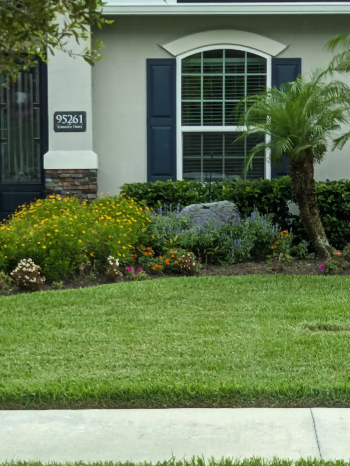 Stone patio installation with integrated plantings in Fernandina Beach