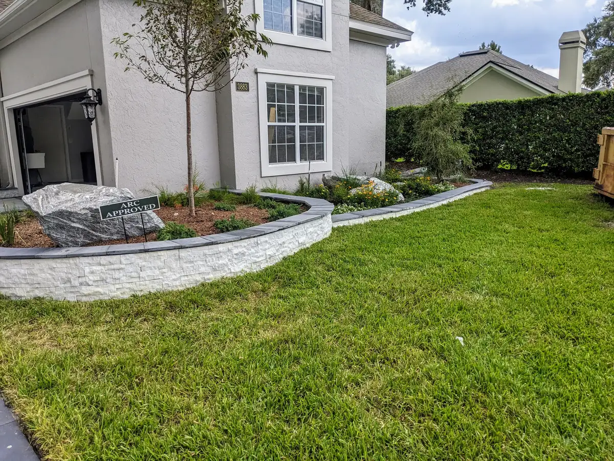 Landscape lighting illuminating a garden path and plantings at dusk