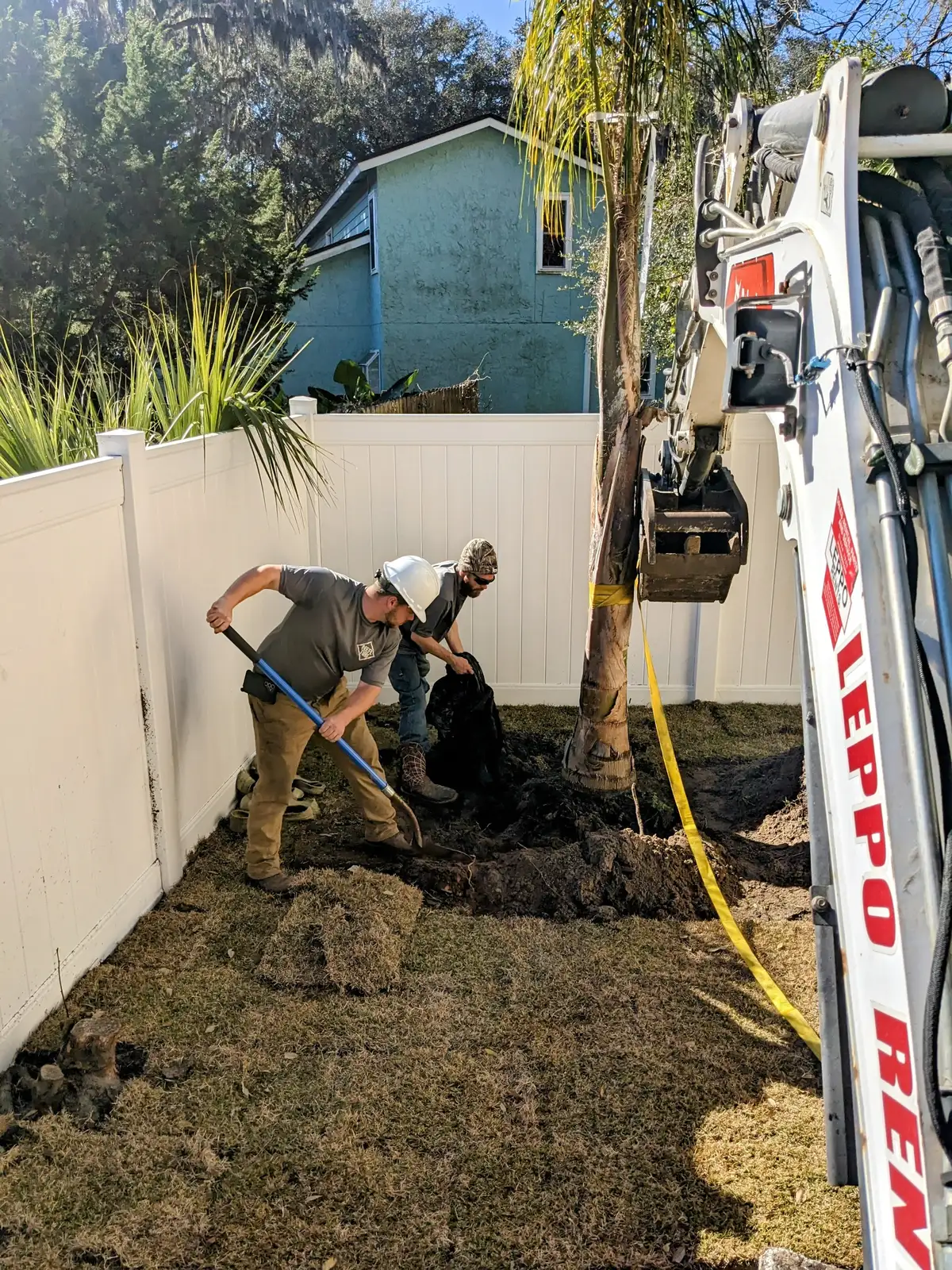 Bloom and Stone Outdoor Designs team member reviewing landscape plans on site
