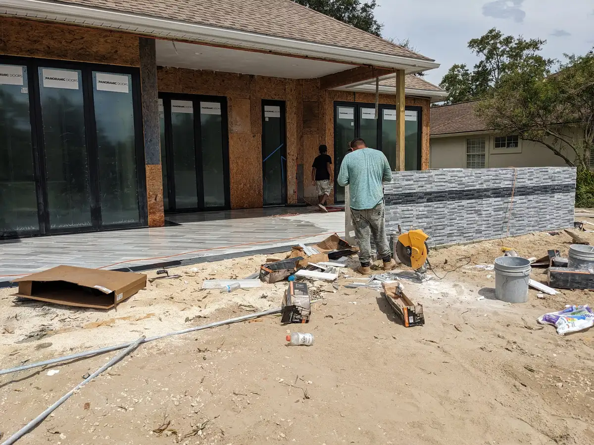 Craftsman building a stone-faced outdoor feature during construction