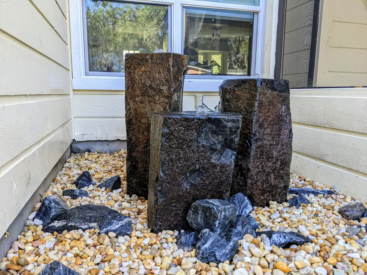 Natural stone water feature with cascading stream in Northeast Florida landscape